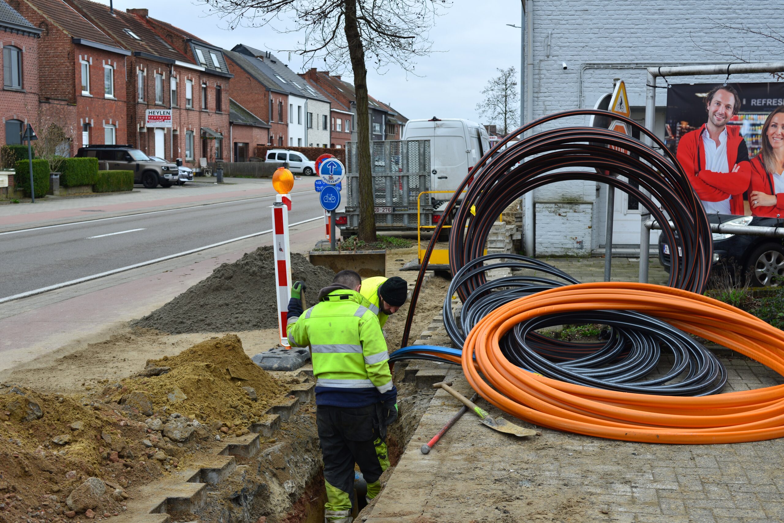 Photo of civil engineering technicians in a trench laying conduits for fibre-optic cables  